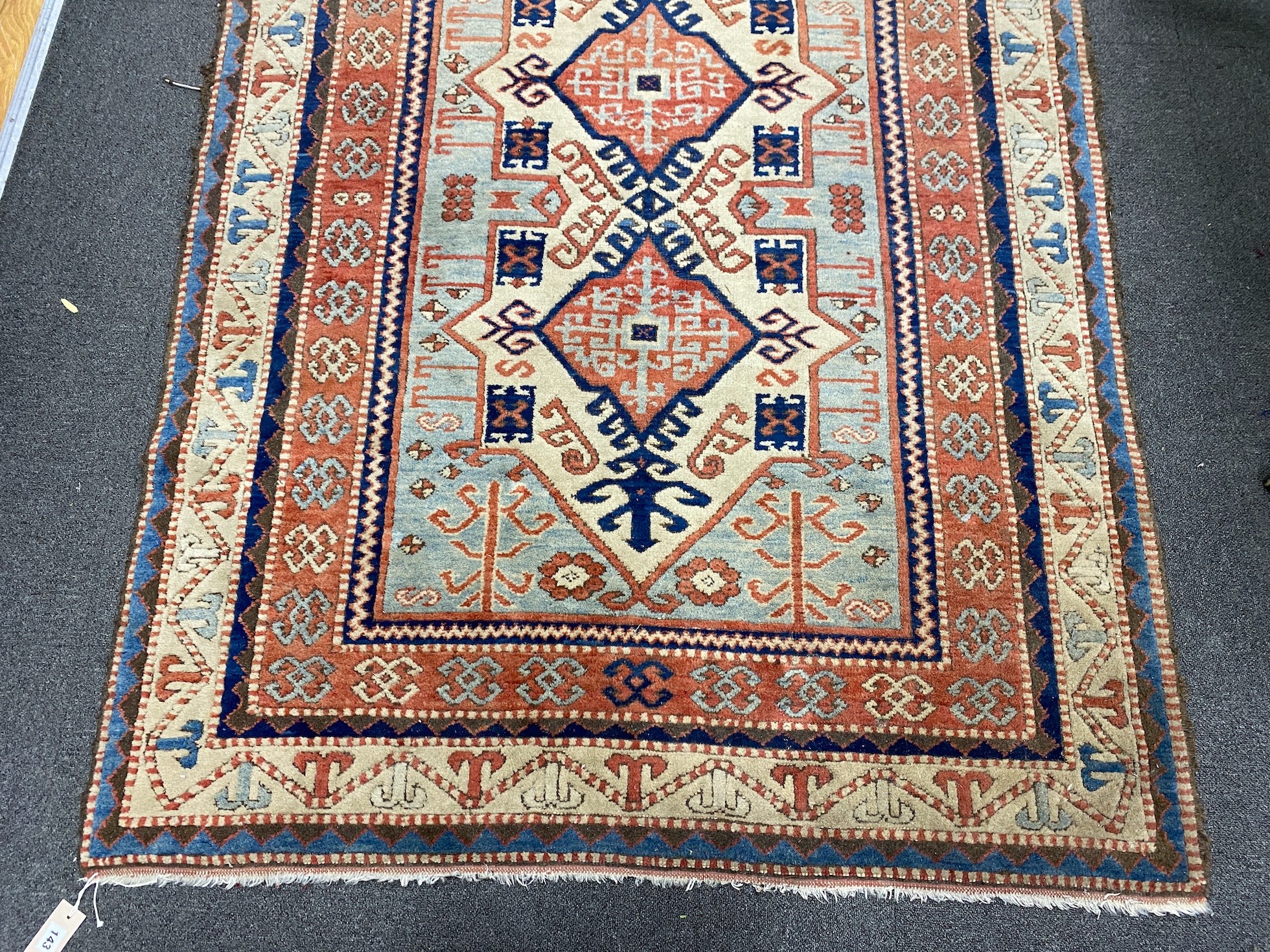A Caucasian style ivory ground rug, 188 x 133cm